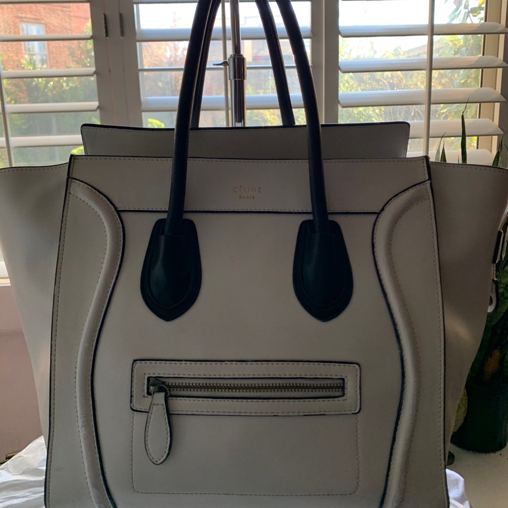 Celine white with black handles made with leather.